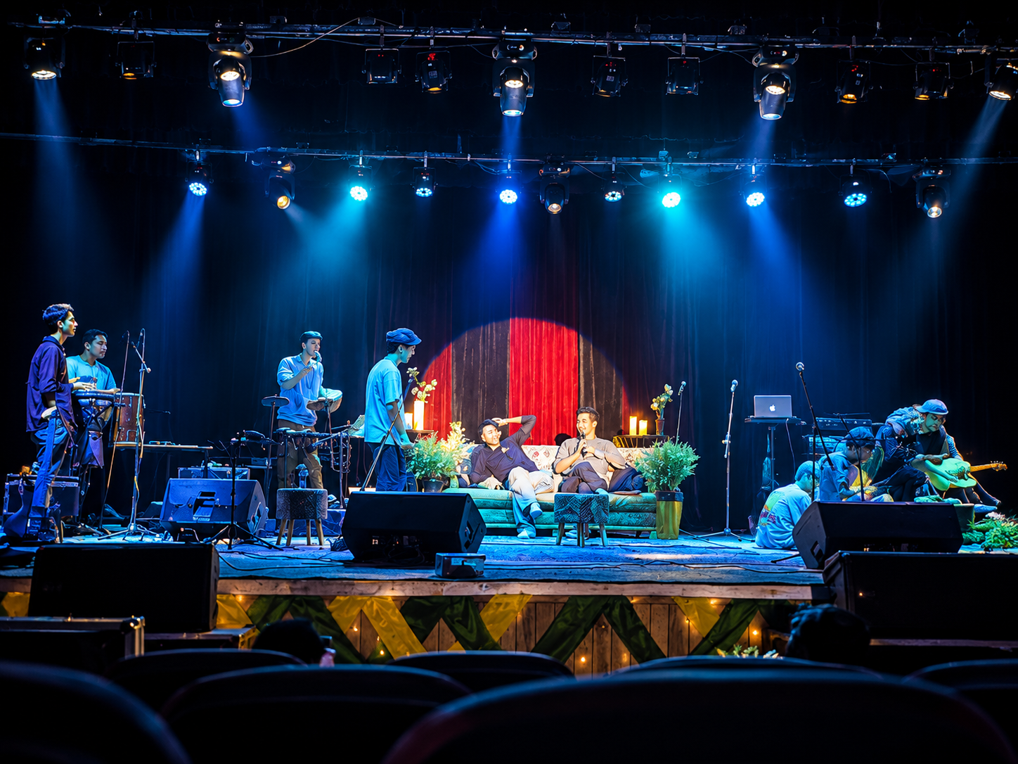 Ensemble performing beneath blue stage lights
