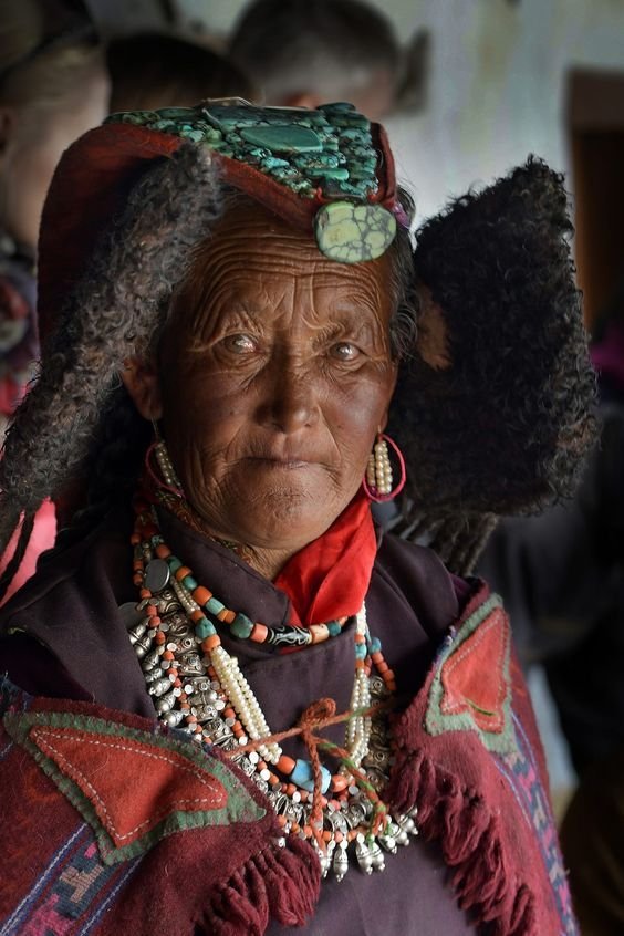 Ladakhi woman in traditional dress wearing a turquoise perak headdress